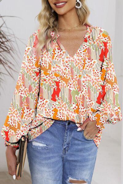 a woman wearing a colorful blouse and ripped jeans