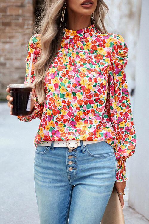 a woman in a colorful shirt holding a cup of coffee