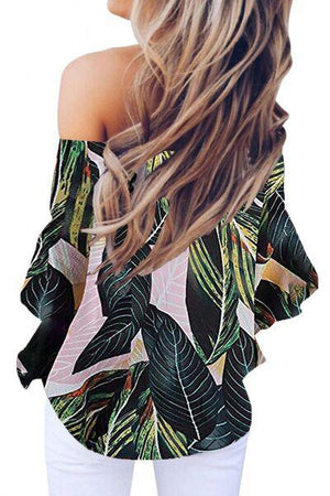 a woman with long hair wearing a top with leaves on it