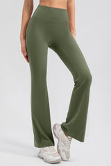 a woman in a crop top and green pants