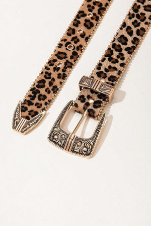 a leopard print belt with a metal buckle