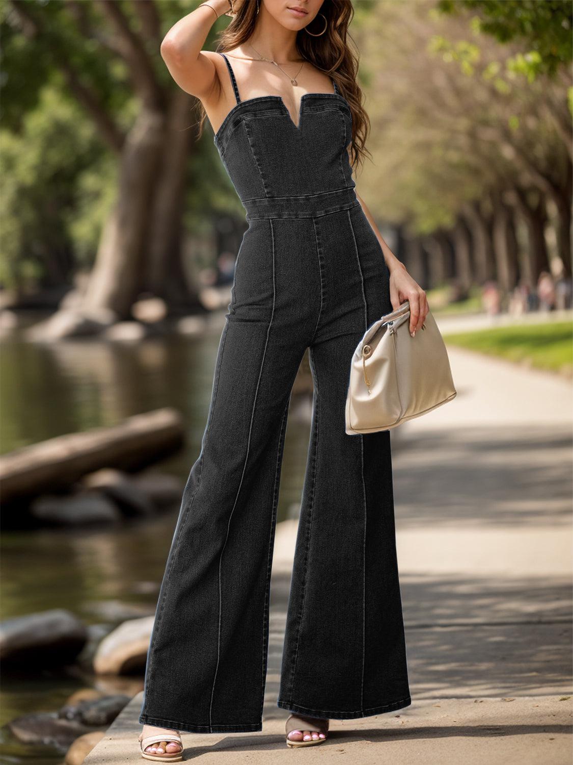 a woman in a black jumpsuit posing for a picture