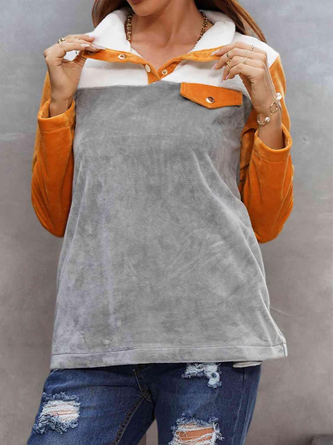 a woman wearing a grey and orange top