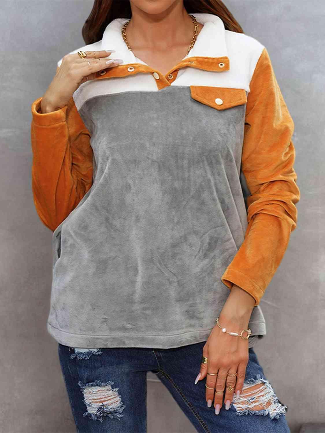a woman wearing a grey and orange top