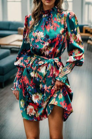 a woman standing in a room wearing a colorful dress