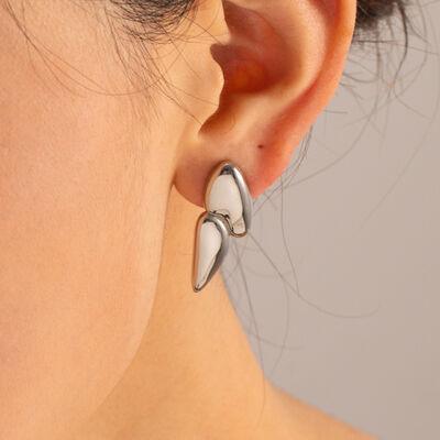 a close up of a person wearing a pair of earrings