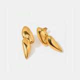 a pair of gold earrings on a white background