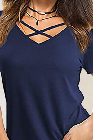 a woman wearing a blue top with a cross back