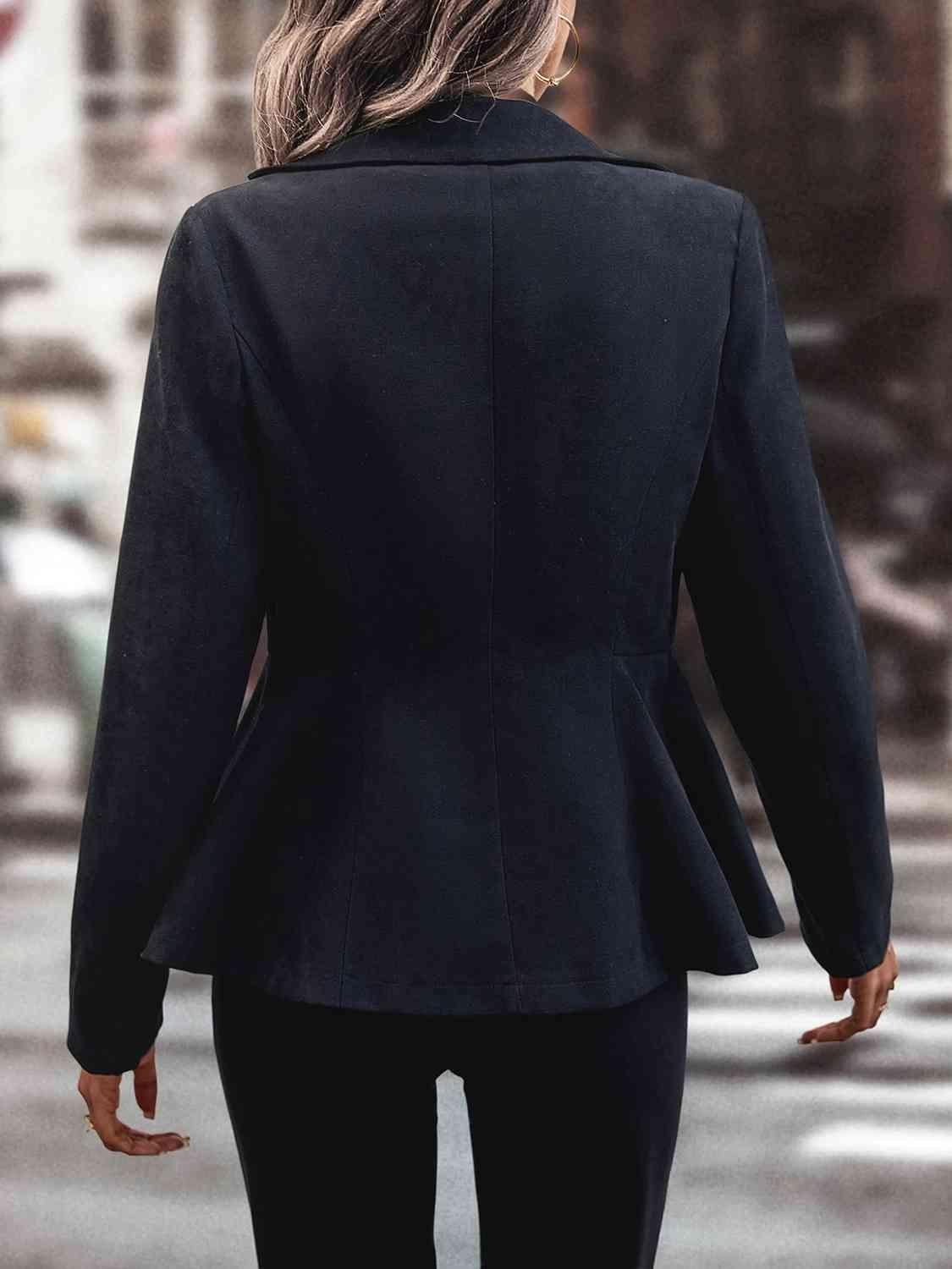 a woman in a black suit is walking down the street