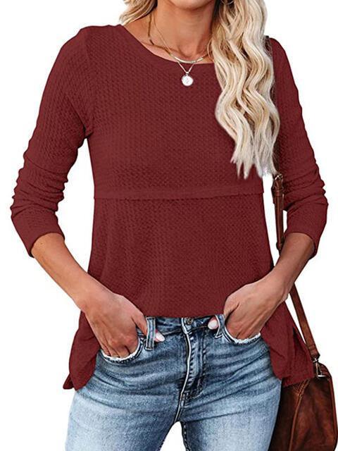 a woman wearing a red sweater and jeans