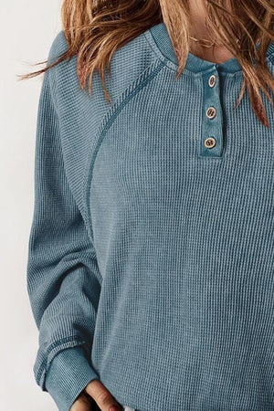 a woman wearing a blue sweater and jeans