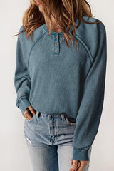 a woman wearing a blue sweater and jeans