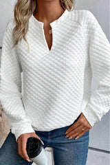 a woman wearing a white sweater and jeans