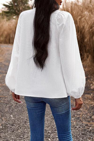 a woman with long hair standing on a road