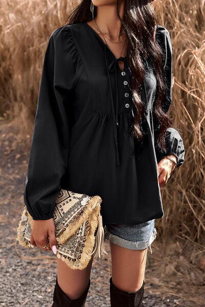 a woman wearing a black blouse and cowboy boots