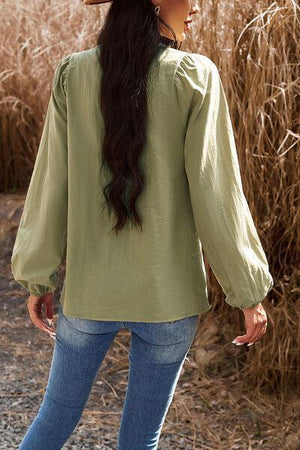 a woman wearing a hat walking in a field