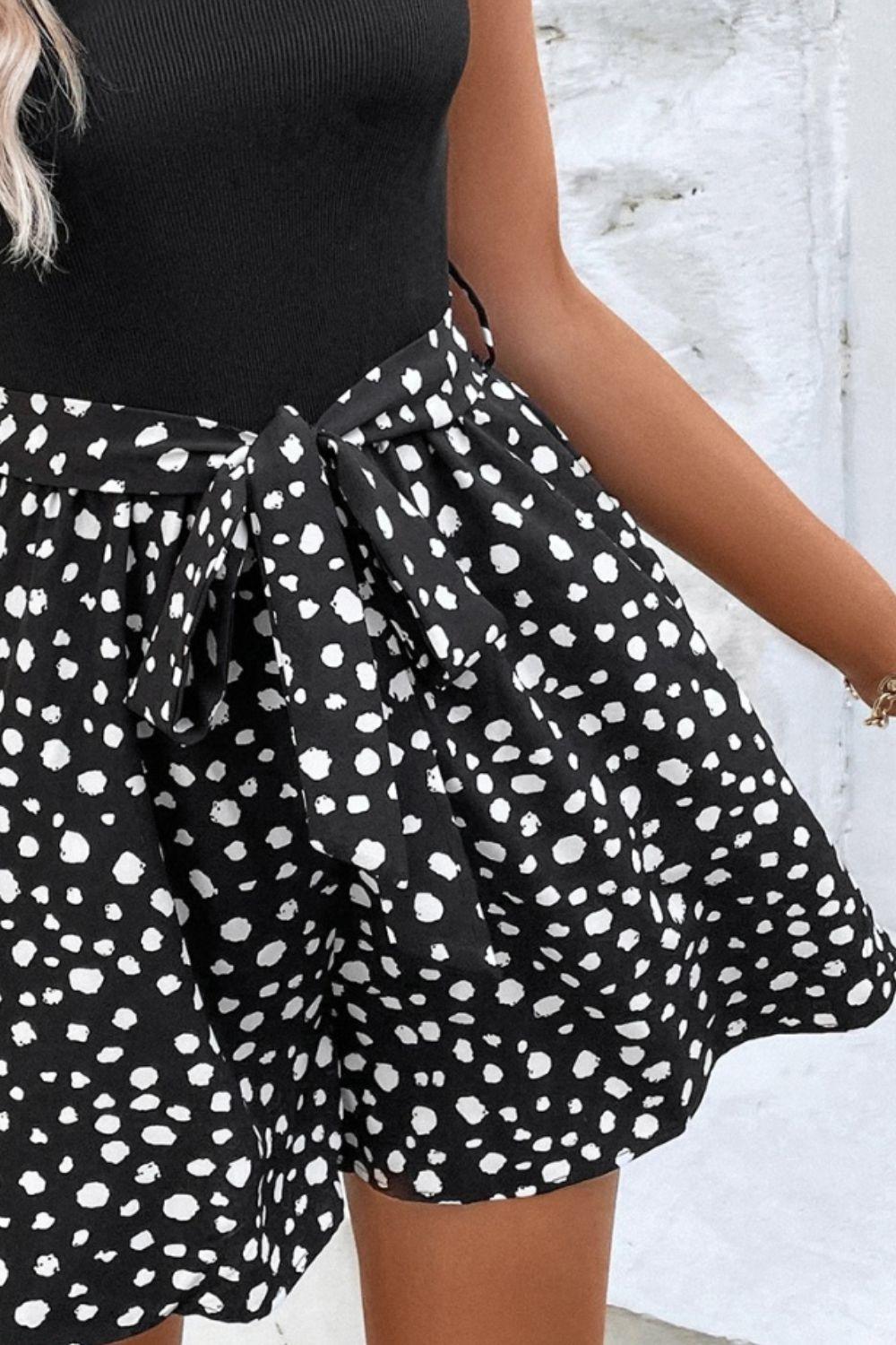 a woman wearing a black and white polka dot skirt