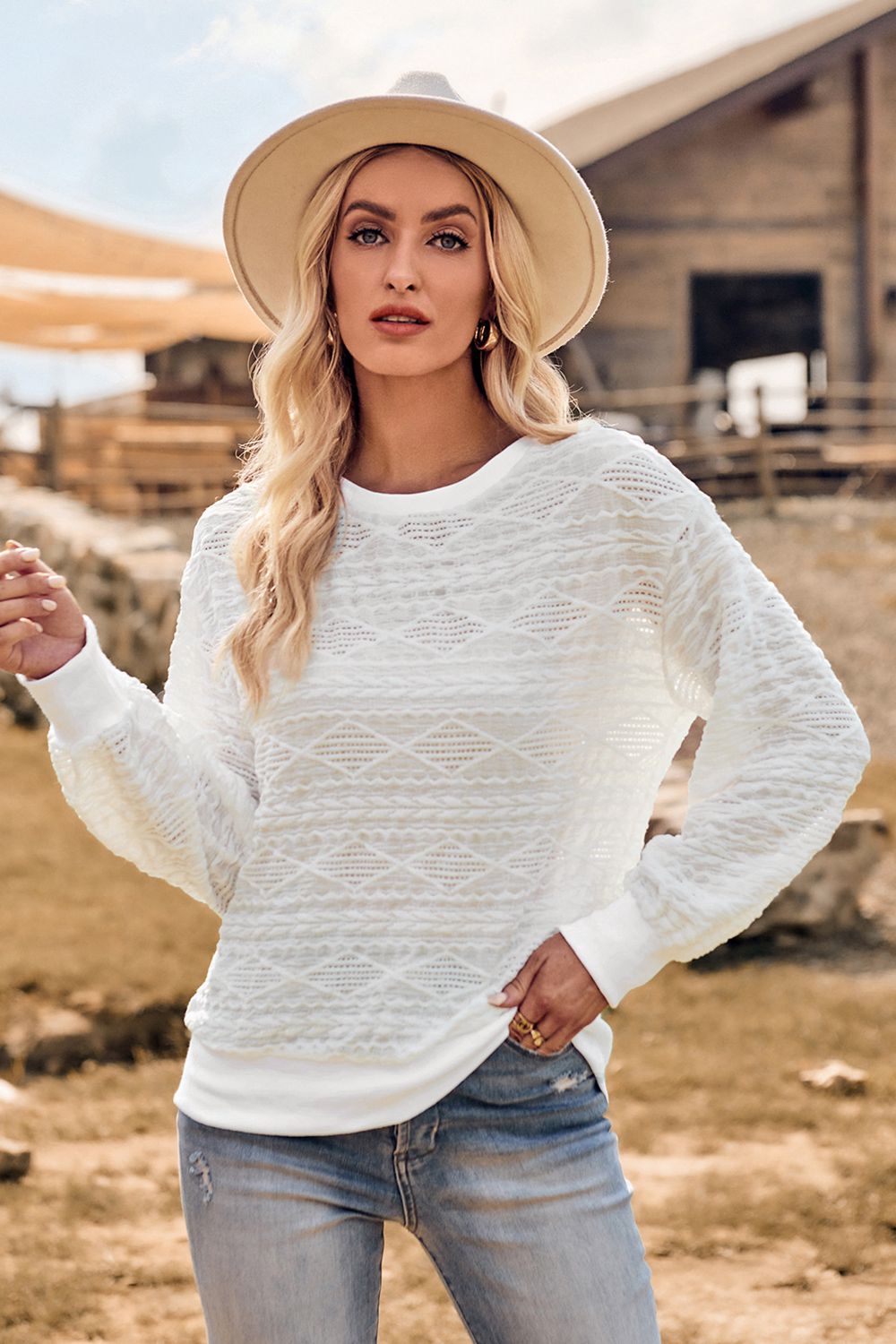 a woman wearing a white sweater and hat