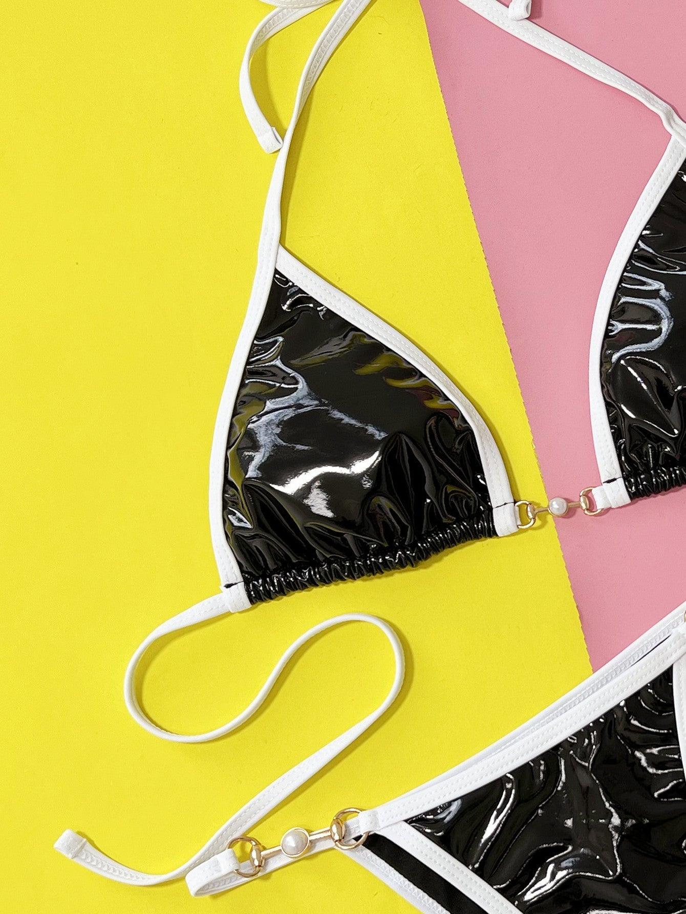 a black and white bikini top and a yellow and pink background