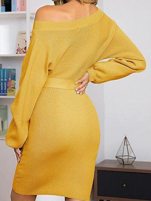 a woman in a yellow sweater dress