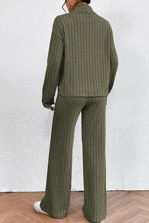 a woman in a green sweater and pants