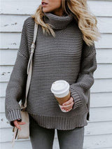 a woman wearing a sweater and leggings holding a cup of coffee