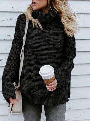 a woman in a black sweater holding a cup of coffee