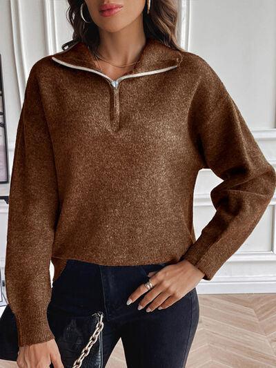 a woman wearing a brown sweater and black pants
