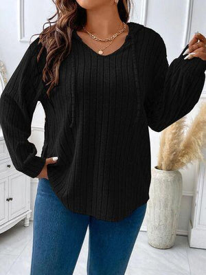 a woman wearing a black sweater and jeans