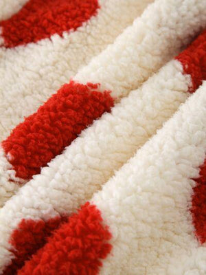 a close up of a red and white blanket