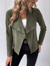 a woman wearing a green jacket and jeans