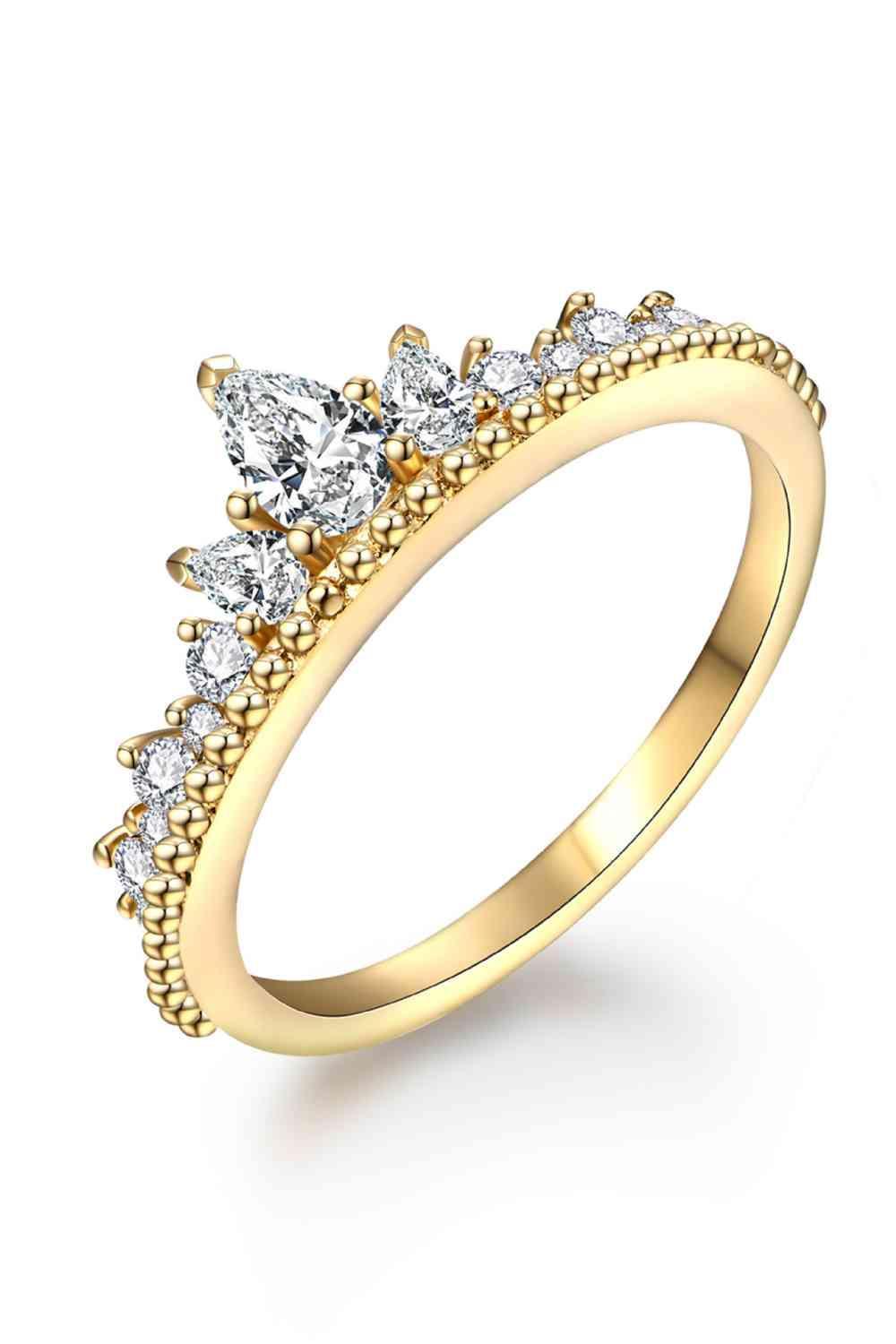 a yellow gold ring with three pear shaped diamonds