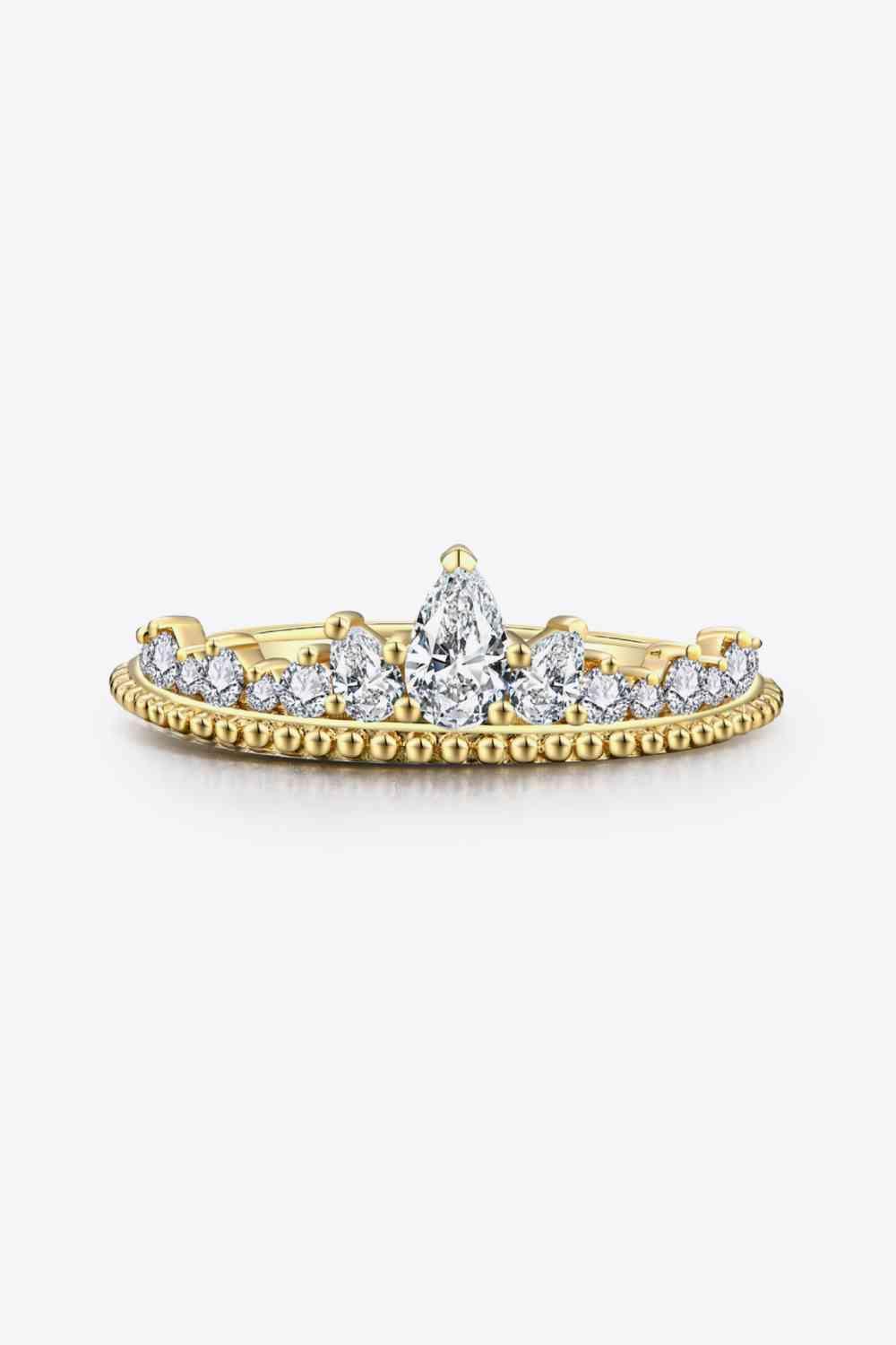 a yellow gold wedding ring set with a pear shaped diamond
