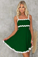 a woman wearing a green and white dress