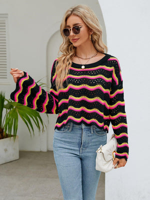 a woman wearing a colorful sweater and jeans