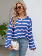 a woman wearing a blue and white striped sweater