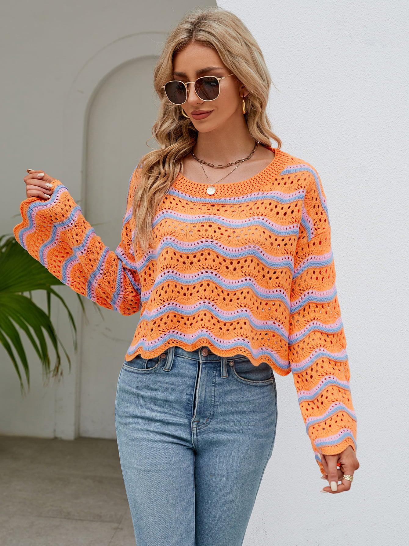 a woman wearing an orange sweater and jeans