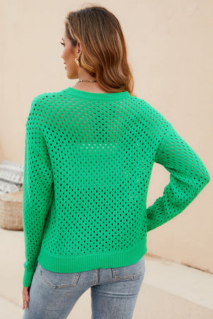 a woman wearing a green sweater and jeans