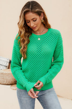 a woman wearing a green sweater and jeans