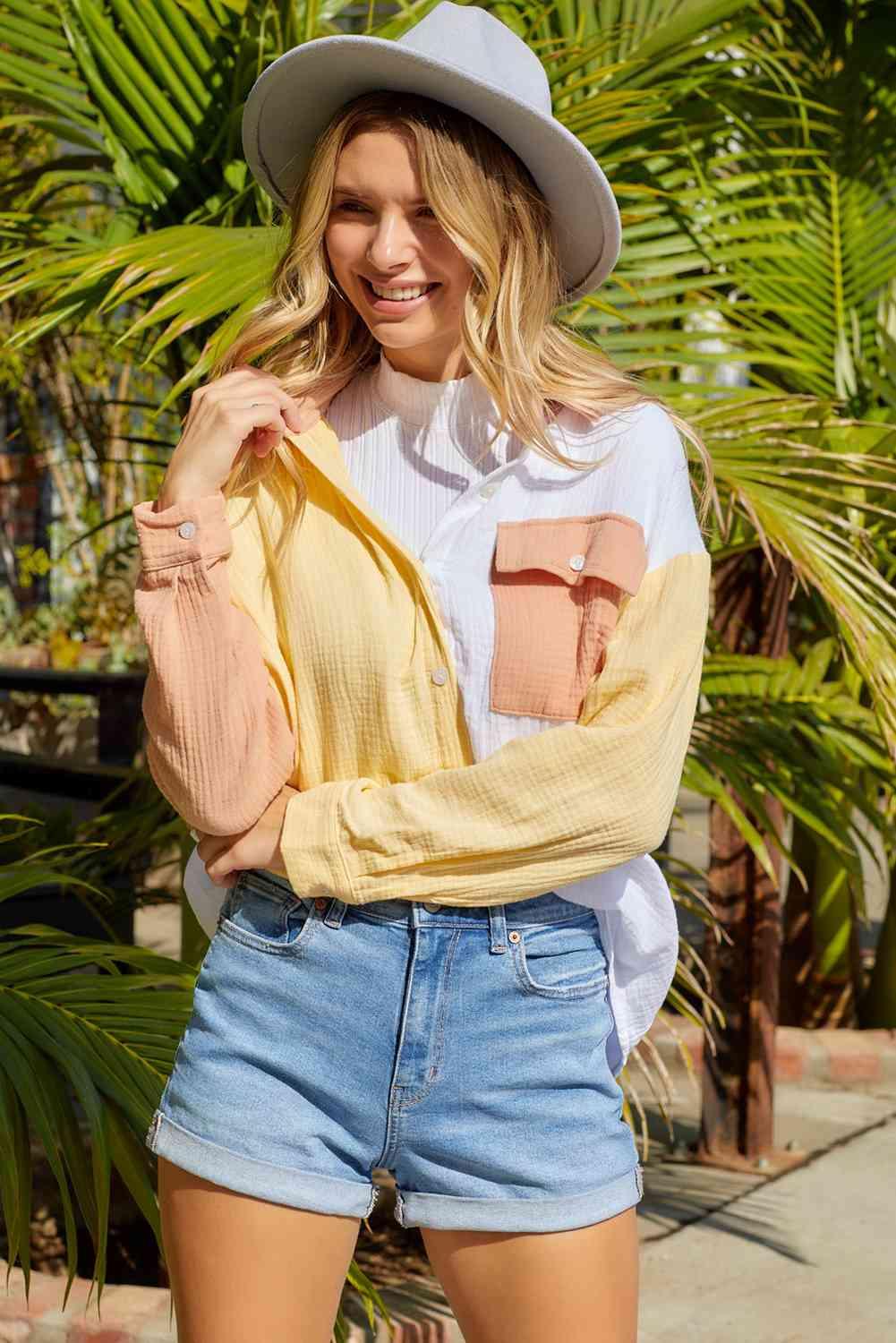 a woman wearing a hat and a yellow sweater