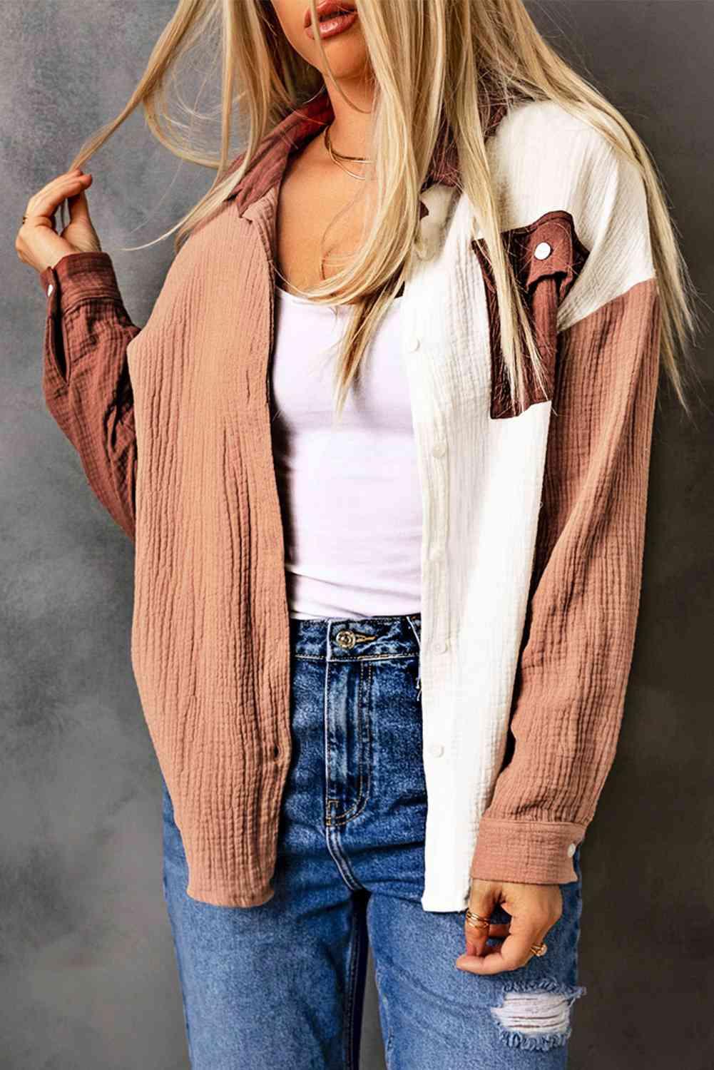 a woman with long hair wearing a jacket and jeans
