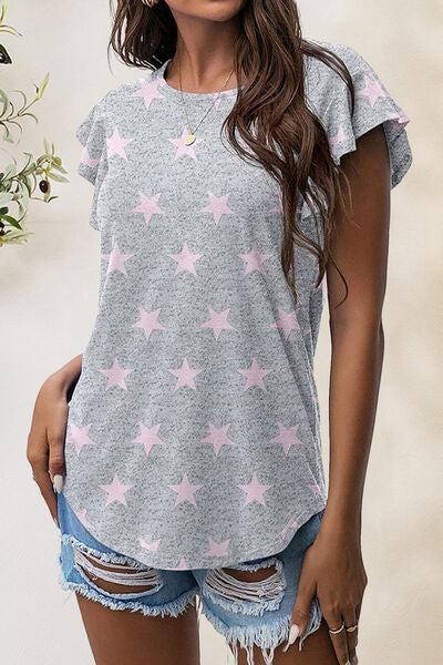 a woman wearing a grey shirt with pink stars on it