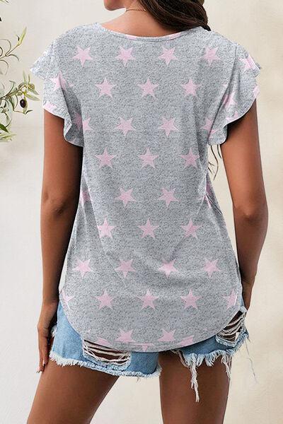 a woman wearing a grey shirt with pink stars on it