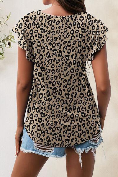 a woman wearing a leopard print top