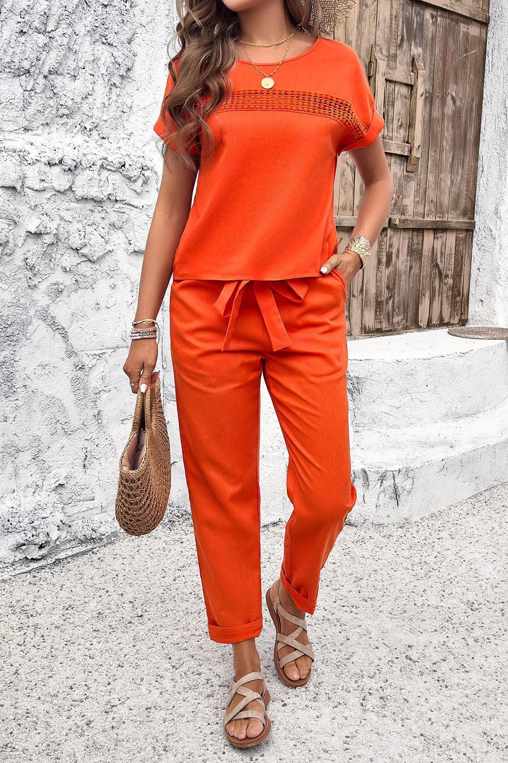 a woman in an orange top and orange pants