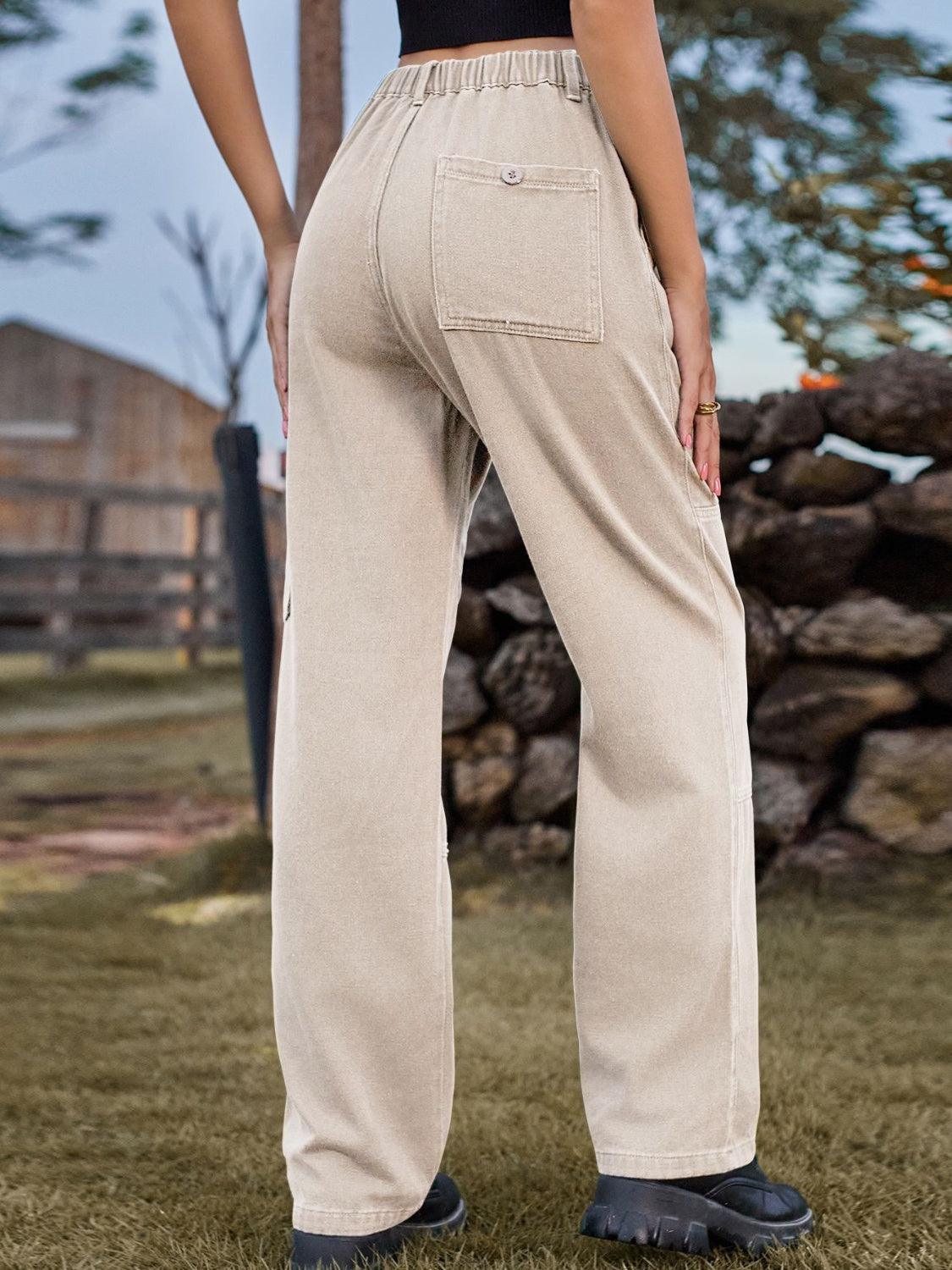 a woman standing in the grass with her back to the camera