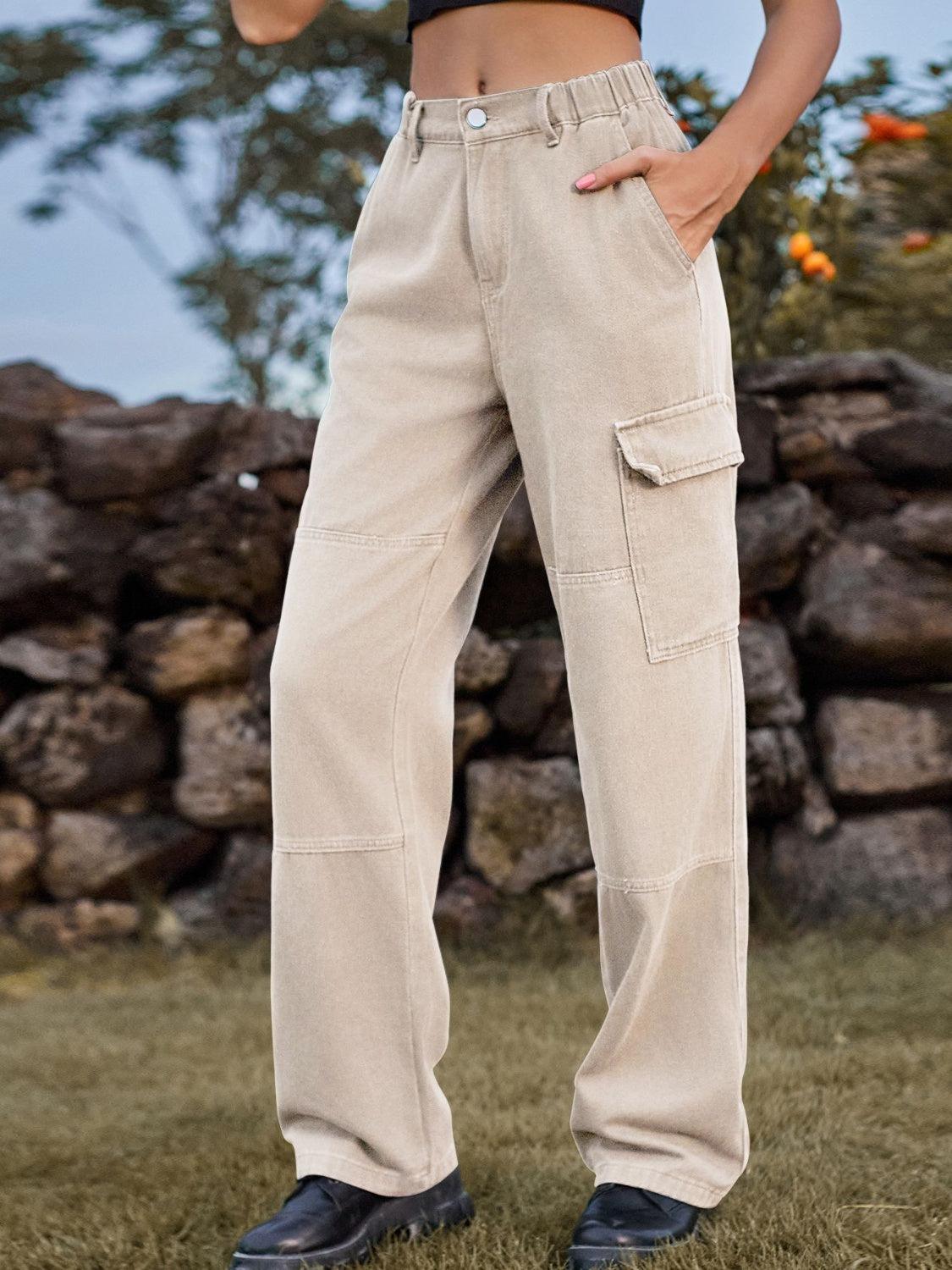 a woman standing in a field with her hands in her pockets