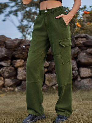 a woman standing in a field with her hands in her pockets