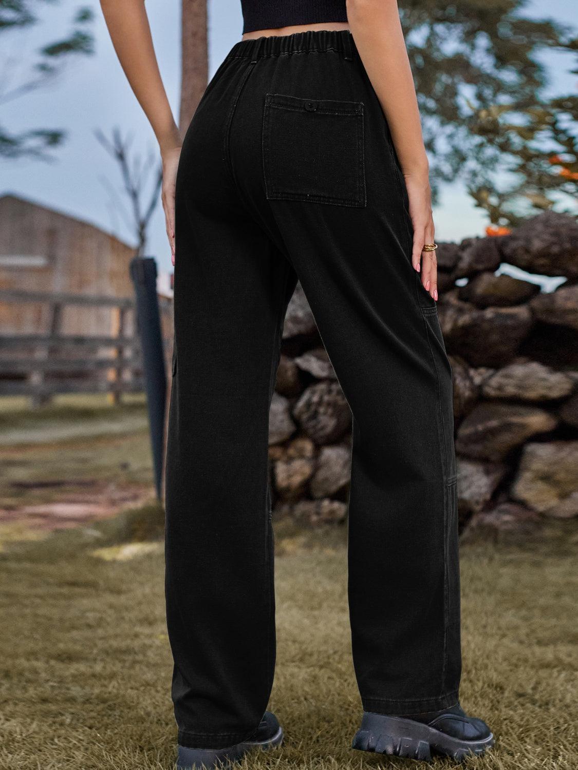 a woman standing in a field with her back to the camera