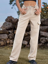 a woman standing in a field with her hands in her pockets